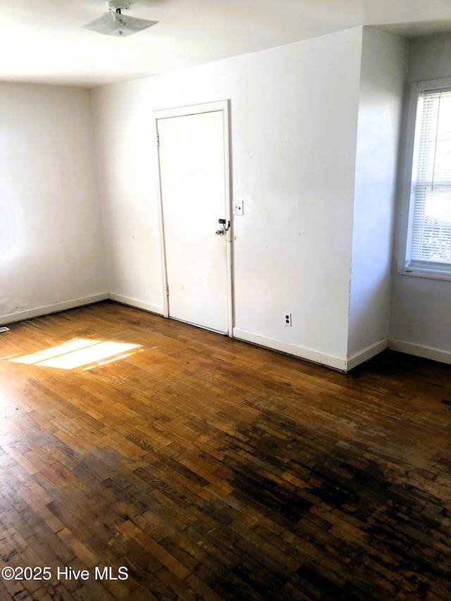 spare room featuring dark hardwood / wood-style floors