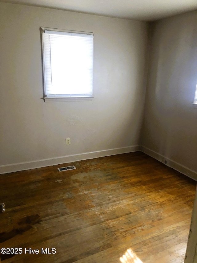 spare room featuring dark hardwood / wood-style floors