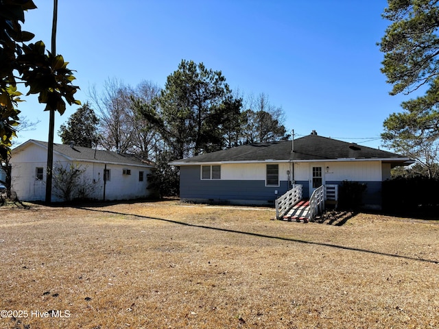 back of house with a lawn