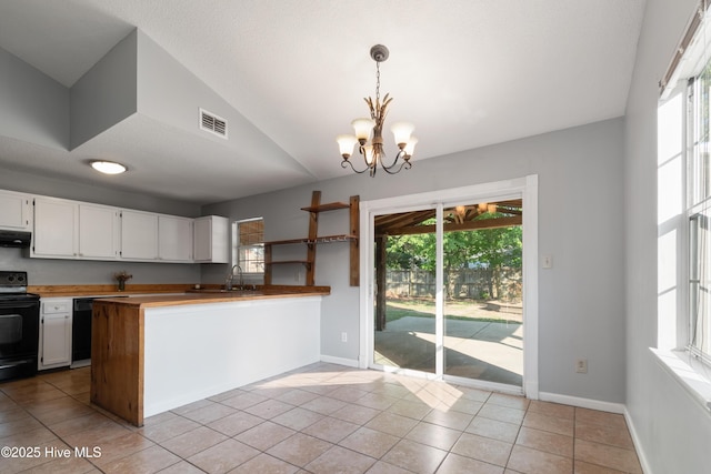 kitchen with a sink, black appliances, visible vents, an inviting chandelier, and white cabinets
