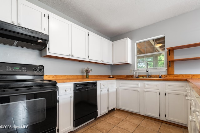 kitchen with light tile patterned floors, black appliances, white cabinets, and under cabinet range hood