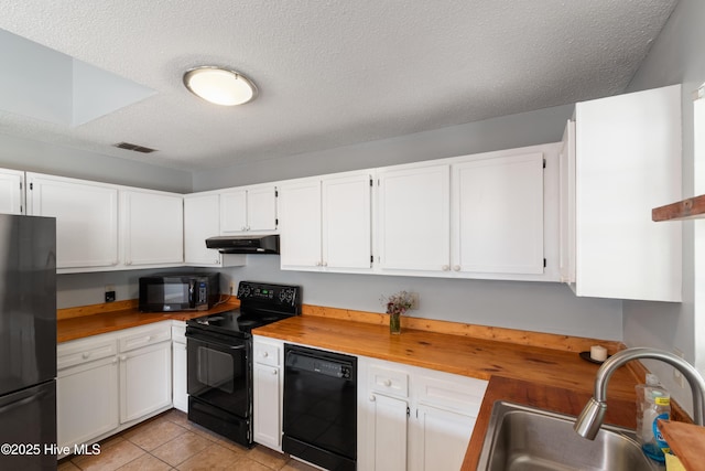 kitchen featuring a sink, white cabinets, visible vents, black appliances, and under cabinet range hood