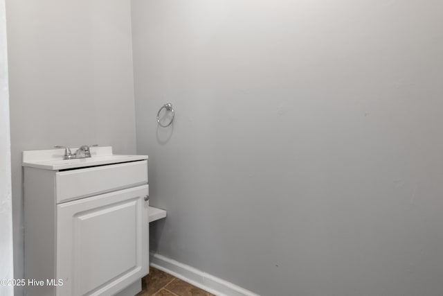 bathroom with vanity and baseboards
