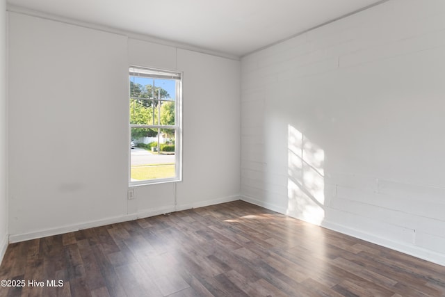 empty room featuring wood finished floors and baseboards