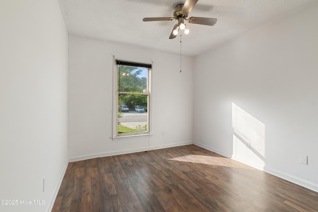 spare room with a textured ceiling, baseboards, a ceiling fan, and wood finished floors