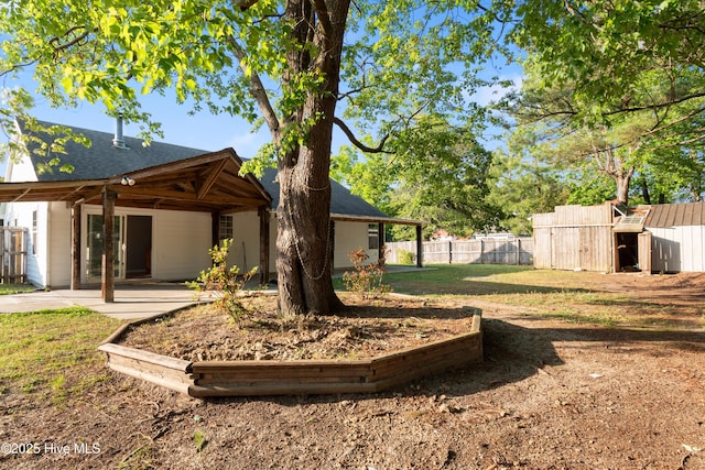 view of yard with fence and a patio