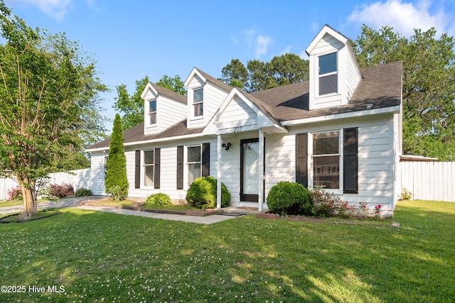 cape cod-style house with fence and a front yard