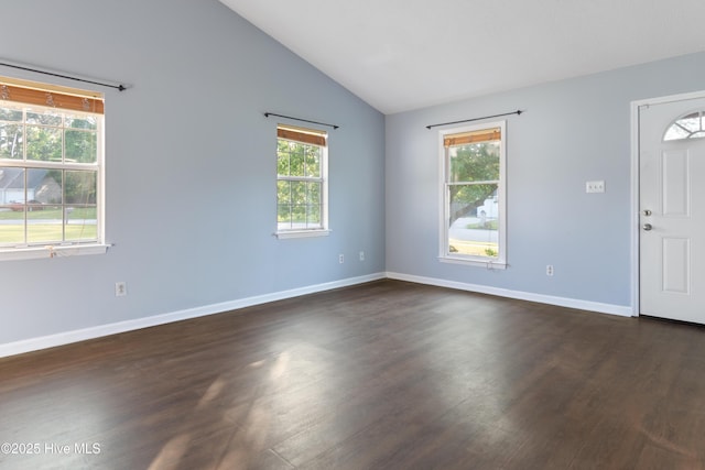 foyer entrance featuring dark wood-type flooring, baseboards, and lofted ceiling