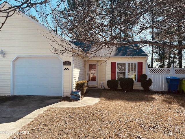 view of front of home with a garage, driveway, fence, and entry steps