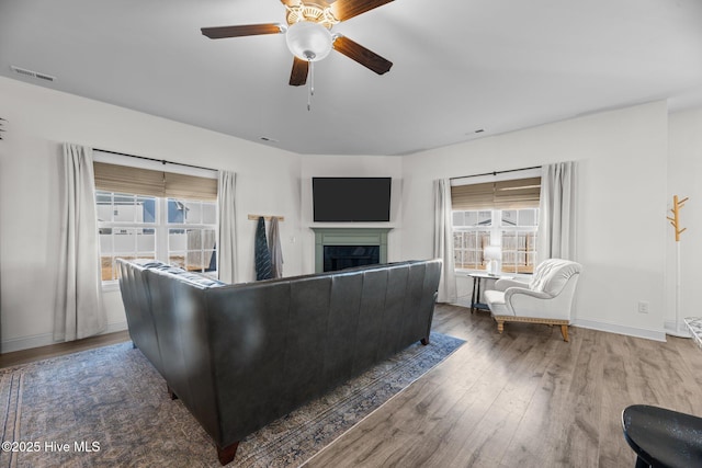 living room with wood-type flooring and ceiling fan