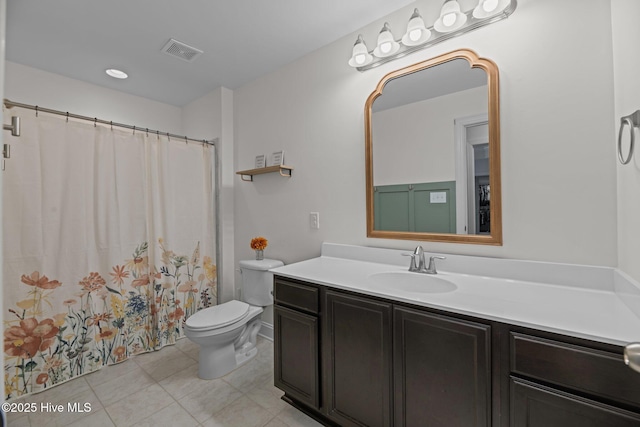 bathroom with tile patterned flooring, vanity, and toilet