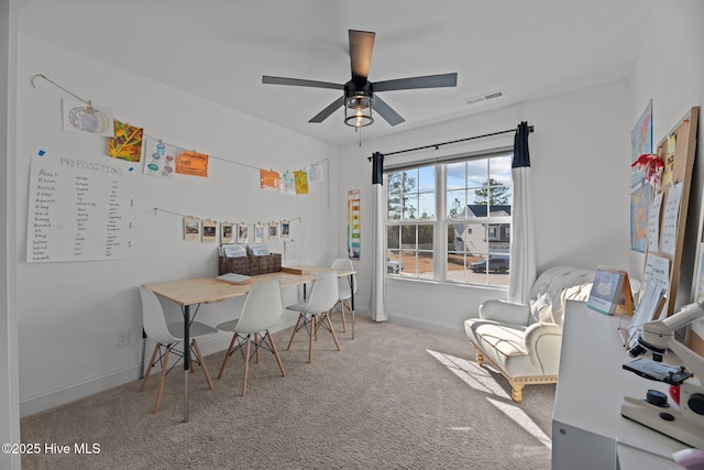 carpeted office featuring ceiling fan