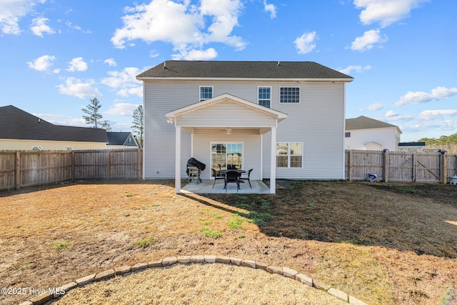 rear view of property featuring a yard, a patio, and ceiling fan