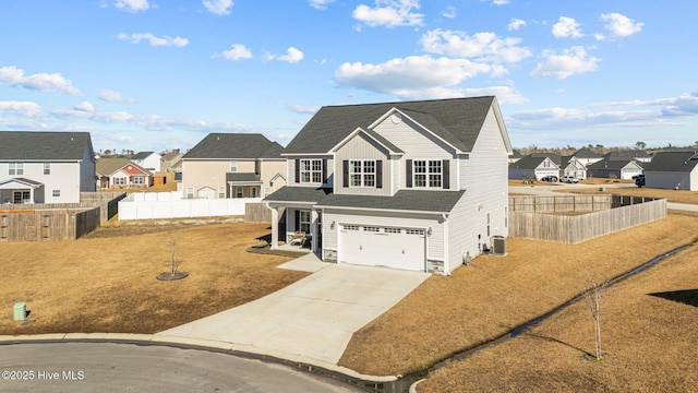 view of property featuring a garage, central AC, and a front lawn