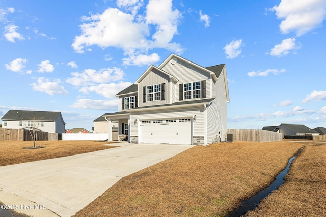 view of front of property featuring a garage, a front yard, and central AC unit