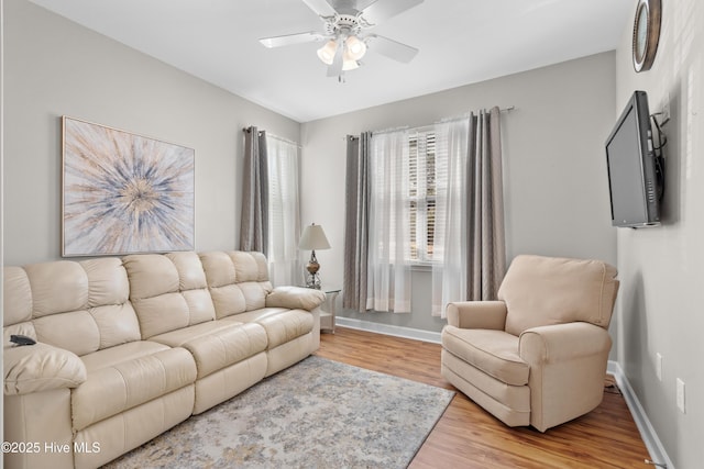 living room with hardwood / wood-style floors and ceiling fan