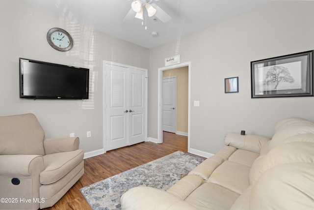 living room with hardwood / wood-style flooring and ceiling fan