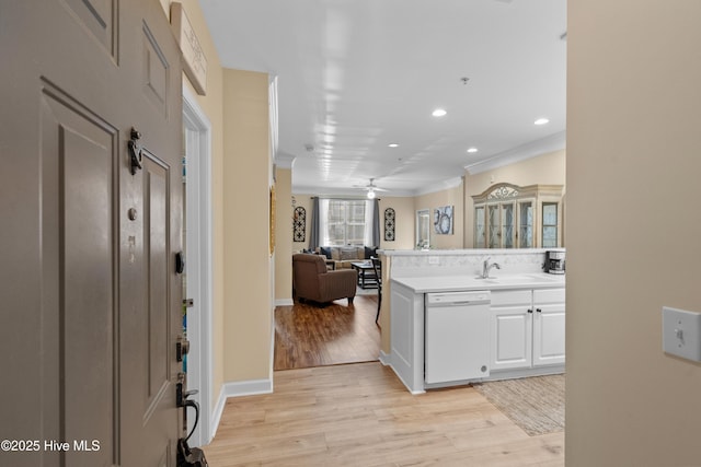 kitchen featuring light hardwood / wood-style flooring, ornamental molding, dishwasher, ceiling fan, and white cabinets