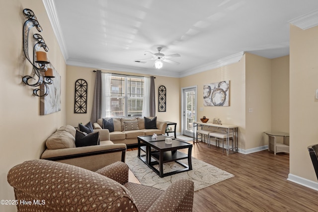 living room featuring hardwood / wood-style flooring, crown molding, and ceiling fan