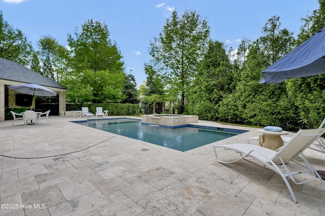 view of swimming pool featuring a pool with connected hot tub and a patio area