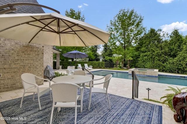 view of pool featuring a patio and a pool with connected hot tub