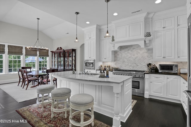 kitchen featuring white cabinetry, backsplash, visible vents, and appliances with stainless steel finishes