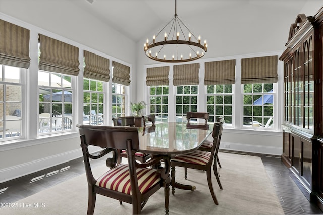 sunroom / solarium featuring a chandelier