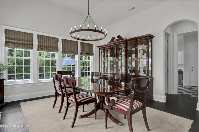 dining room with an inviting chandelier, arched walkways, baseboards, and visible vents