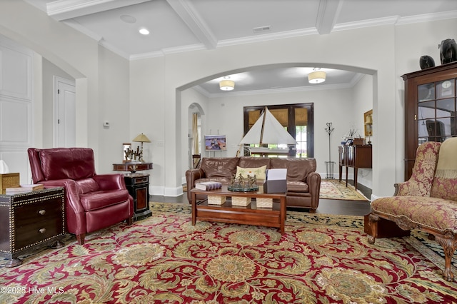 living room featuring ornamental molding, arched walkways, visible vents, and wood finished floors
