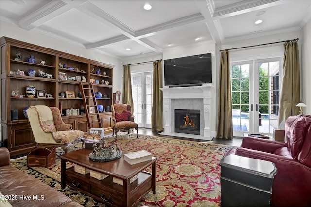 living room with coffered ceiling, a wealth of natural light, and beam ceiling