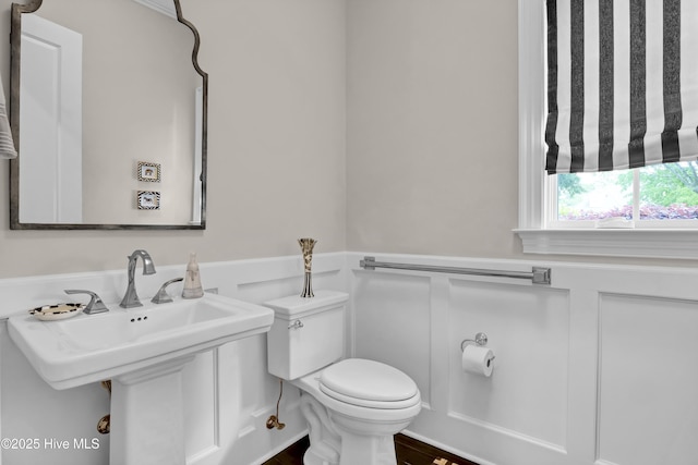 half bath with toilet and a sink