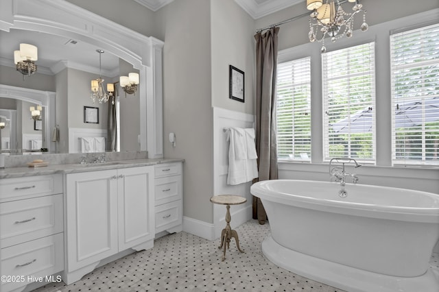 bathroom with a soaking tub, ornamental molding, and a notable chandelier