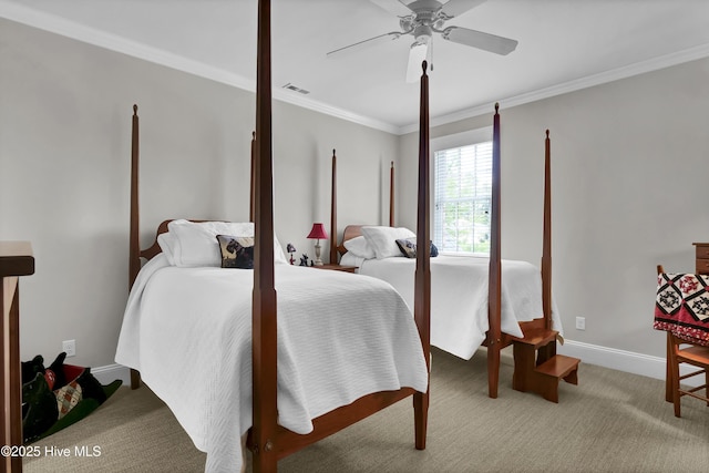 carpeted bedroom with ceiling fan, visible vents, baseboards, and ornamental molding