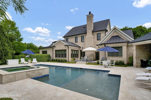 view of pool featuring a pool with connected hot tub and a patio area