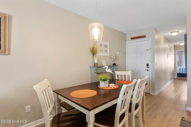 1505 Carolina Beach Ave N Unit 2F, Carolina Beach, NC 28428 - dining room with light wood finished floors and a textured ceiling