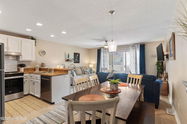 1505 Carolina Beach Ave N Unit 2F, Carolina Beach, NC 28428 - dining space featuring a textured ceiling, recessed lighting, and a ceiling fan