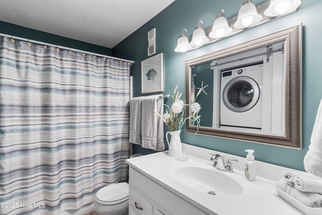 1505 Carolina Beach Ave N Unit 2F, Carolina Beach, NC 28428 - bathroom featuring vanity, a textured ceiling, a shower with curtain, and stacked washer / drying machine