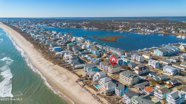 bird's eye view featuring a view of the beach and a water view