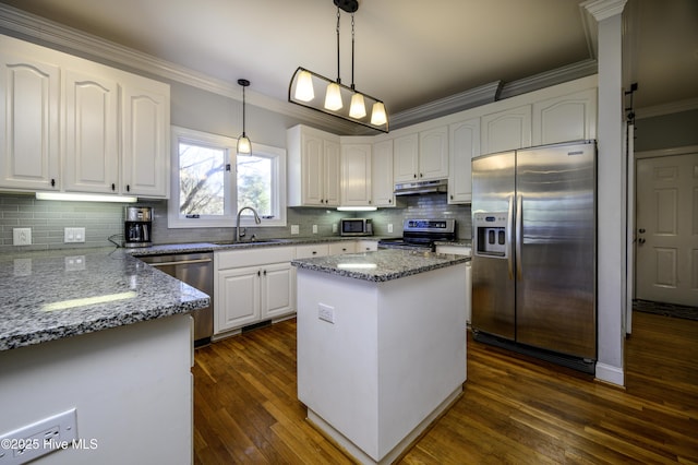 kitchen with sink, decorative light fixtures, a center island, stainless steel appliances, and white cabinets