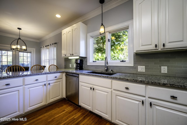 kitchen with sink, white cabinetry, hanging light fixtures, dark stone countertops, and stainless steel dishwasher