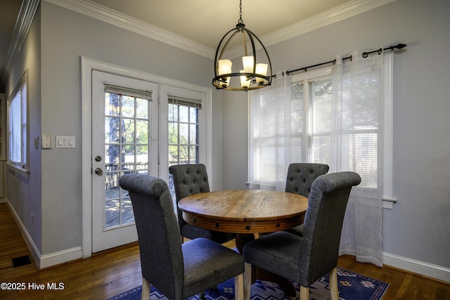 dining room featuring crown molding, a chandelier, and dark hardwood / wood-style flooring