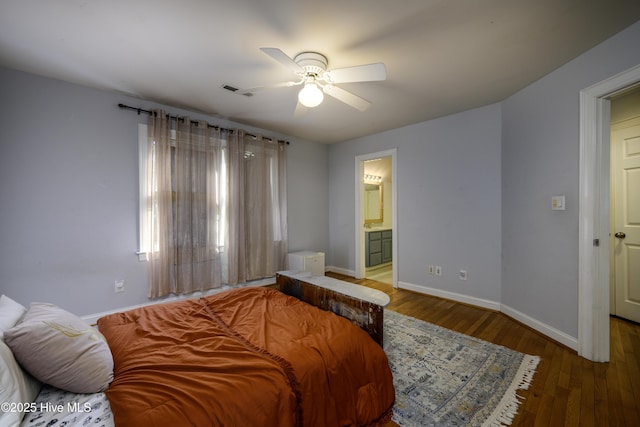 bedroom with wood-type flooring, ceiling fan, and ensuite bath