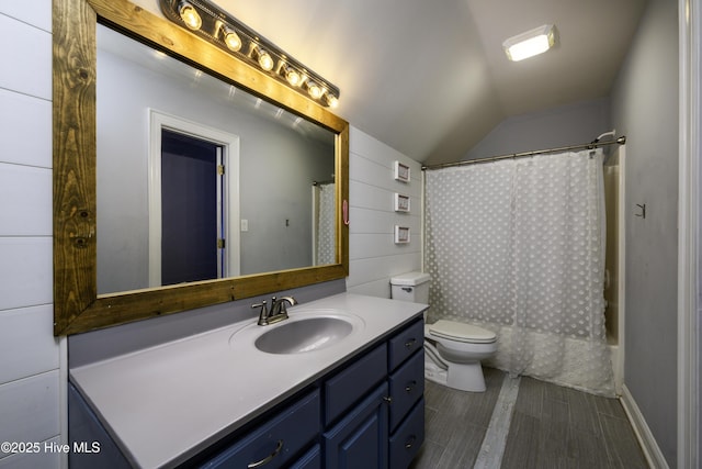 full bathroom with toilet, vaulted ceiling, vanity, shower / bath combination with curtain, and hardwood / wood-style floors