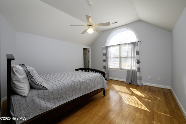 bedroom with hardwood / wood-style flooring, ceiling fan, and lofted ceiling