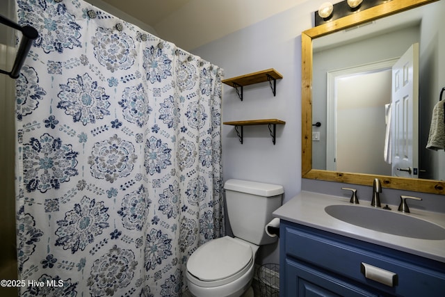 bathroom with a shower with curtain, vanity, and toilet