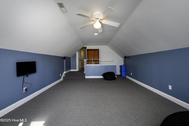 bonus room with dark carpet, ceiling fan, and vaulted ceiling