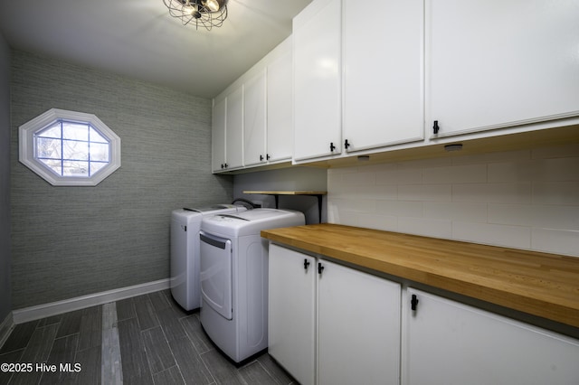 laundry area with washer and clothes dryer and cabinets