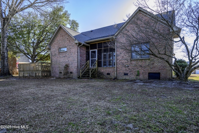 back of property featuring a sunroom and a deck