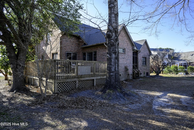 rear view of property featuring a deck