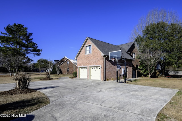 view of property exterior with a garage and a lawn